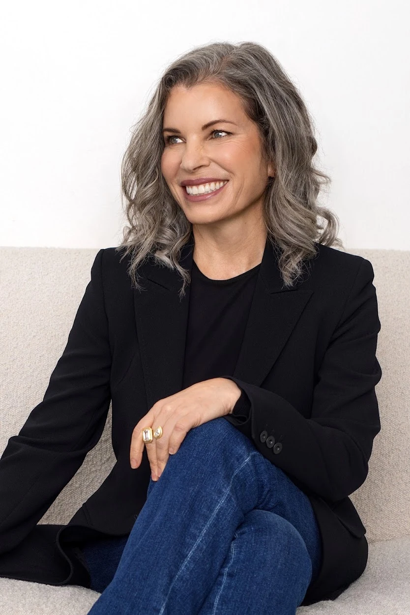 Katie Lever seated in a black blazer